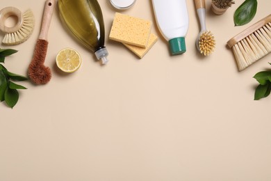 Flat lay composition with different cleaning supplies on beige background. Space for text