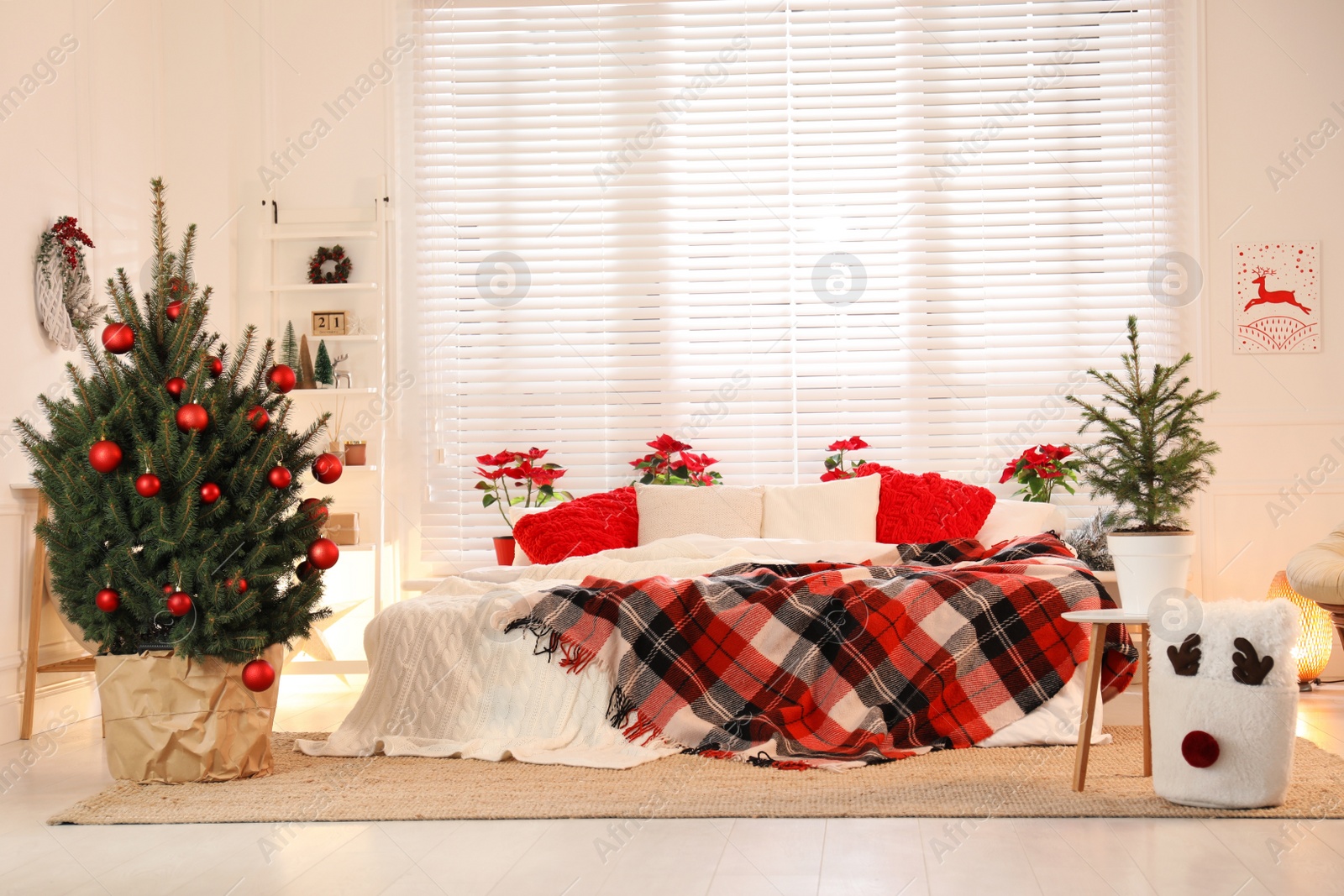 Photo of Beautiful green Christmas trees in bedroom. Interior design