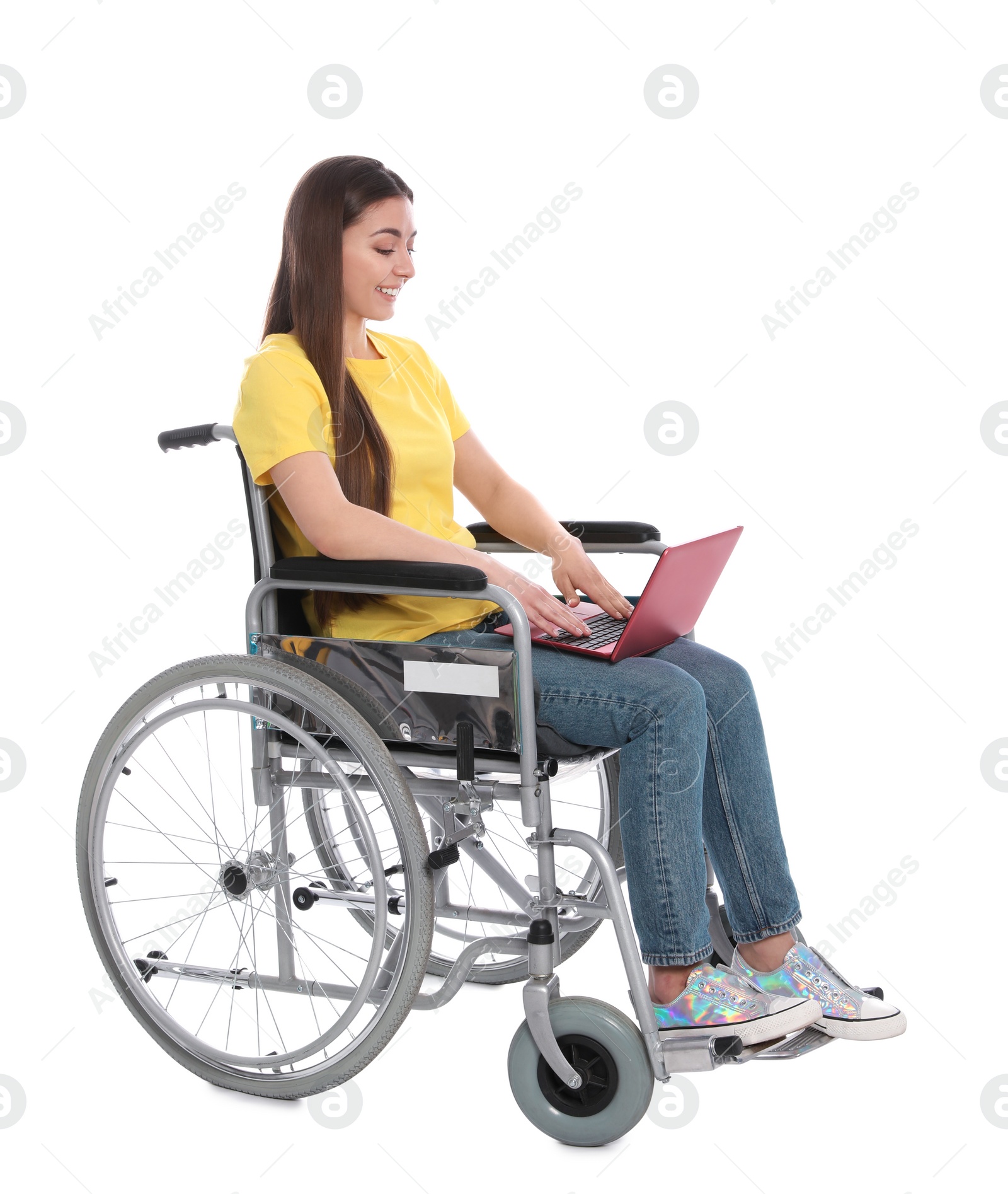 Photo of Young woman in wheelchair using laptop isolated on white