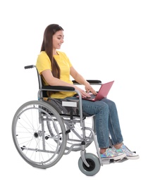 Photo of Young woman in wheelchair using laptop isolated on white