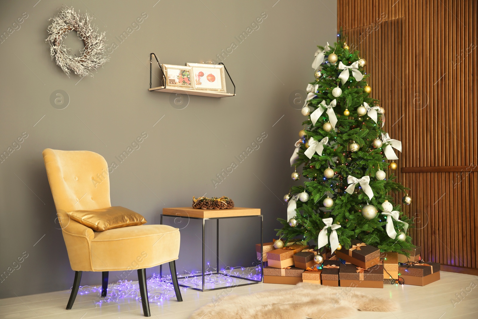 Photo of Room interior with beautiful Christmas tree and gifts