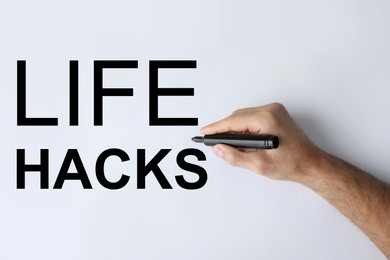 Image of Life hacks. Man underlining word with marker on whiteboard, closeup