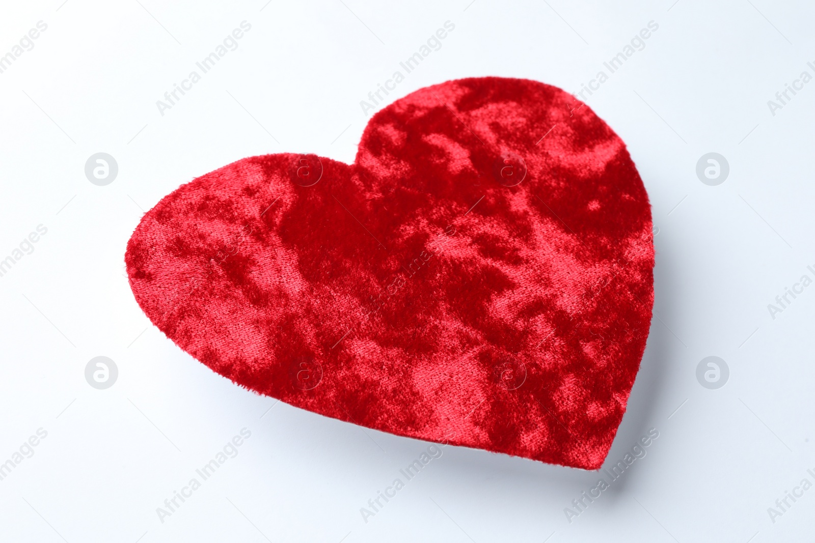 Photo of One red velvet heart on white background