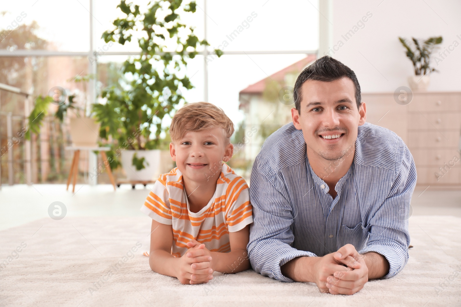 Photo of Father with cute child on floor at home. Happy family