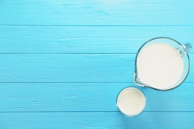 Photo of Glassware with milk on wooden table. Fresh dairy product