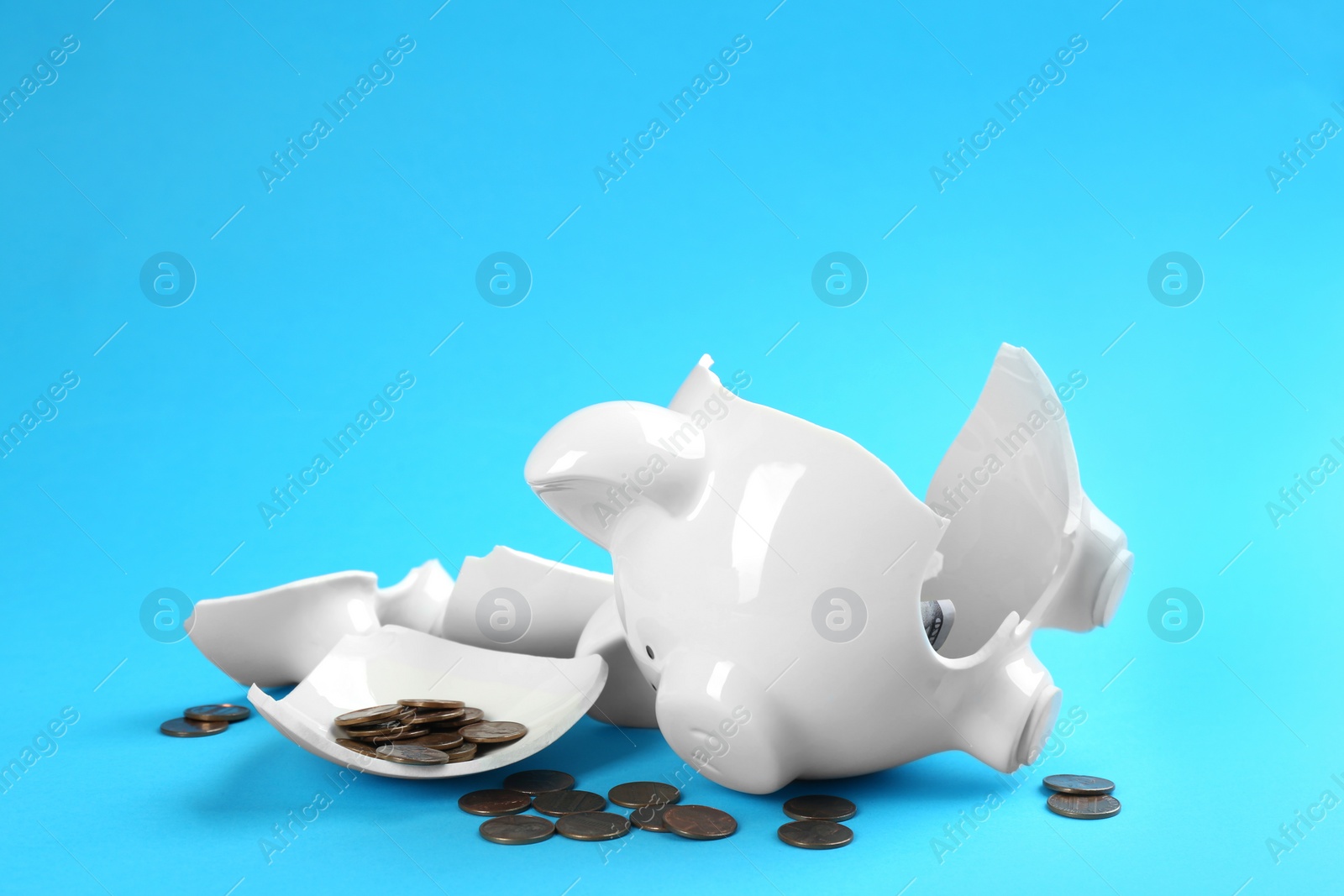 Photo of Broken piggy bank with money on blue background
