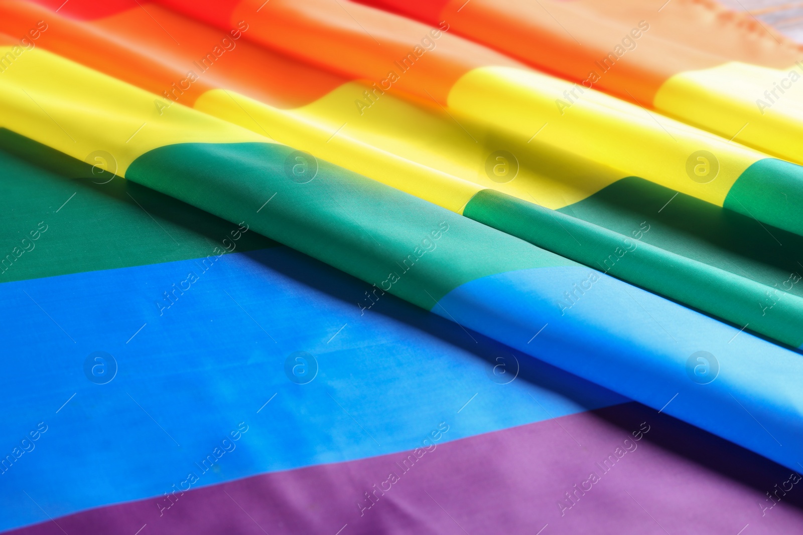 Photo of Bright rainbow gay flag as background. LGBT community