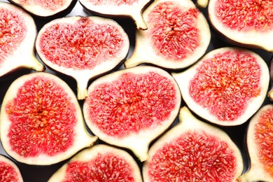 Photo of Cut ripe figs as background, top view