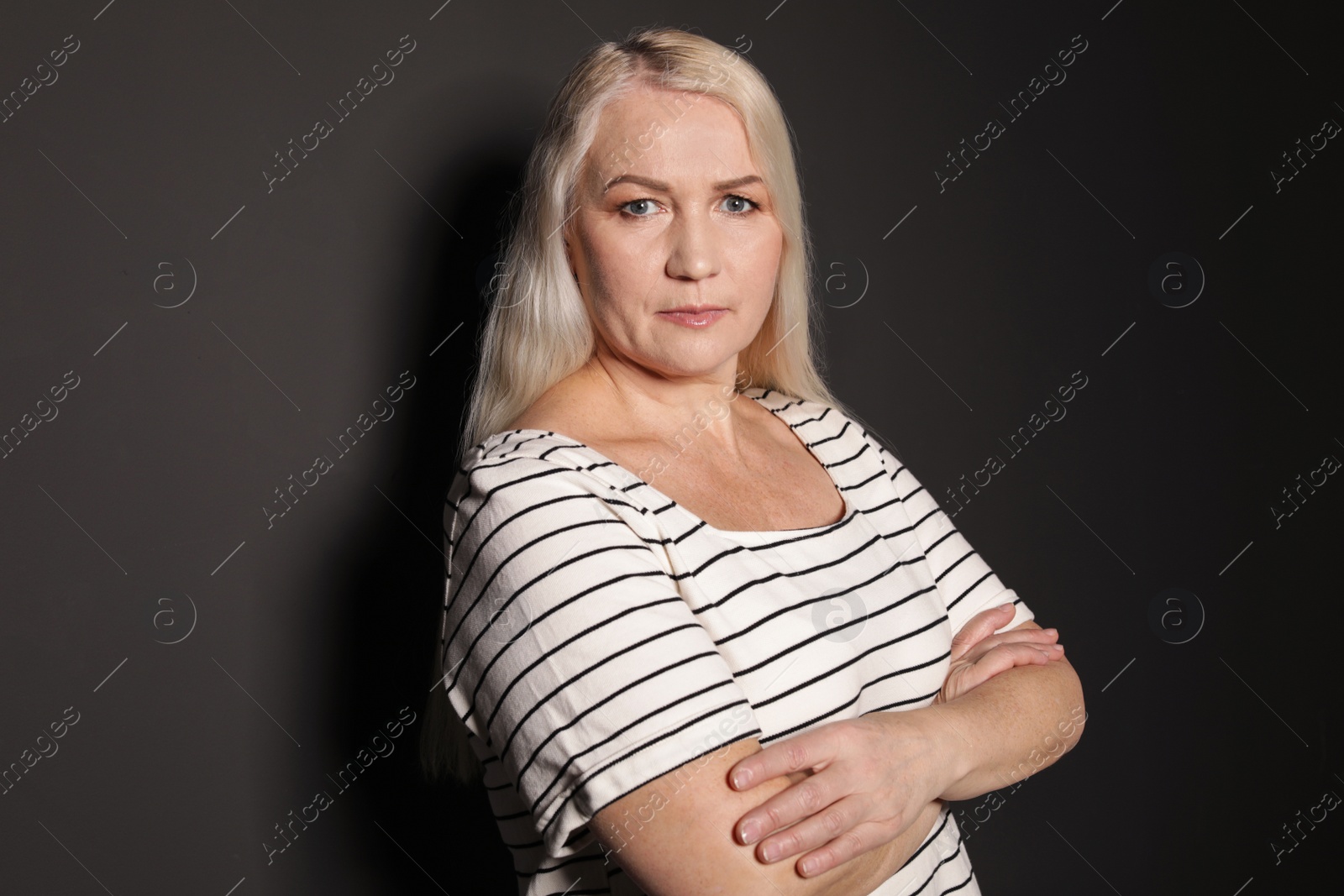 Photo of Portrait of mature woman on black background