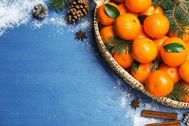 Flat lay composition with tangerines on blue wooden background. Space for text