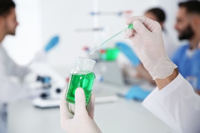 Photo of Medical student working in modern scientific laboratory, closeup