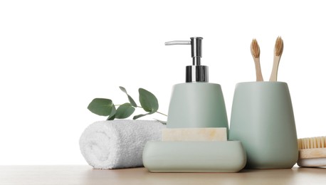 Photo of Bath accessories. Different personal care products and eucalyptus branch on wooden table against white background. Space for text