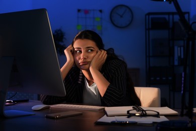 Photo of Tired businesswoman working at night in office