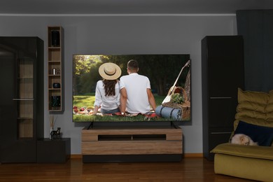 Tv with romantic movie on screen in cozy room