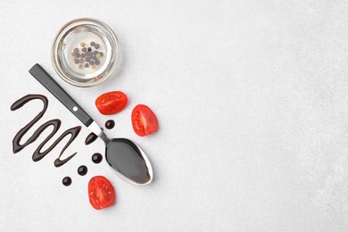 Organic balsamic vinegar and cooking ingredients on white table, flat lay. Space for text