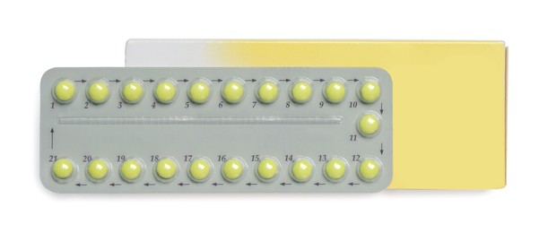 Photo of Birth control pills on white background, top view