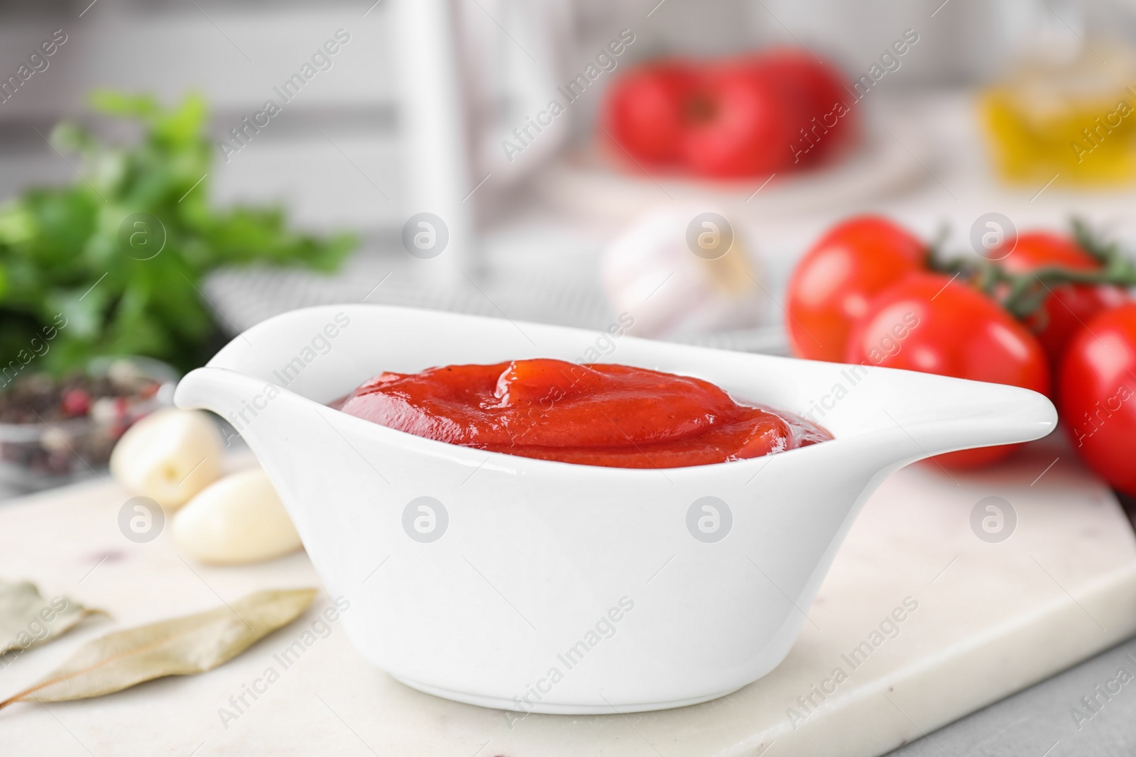 Photo of Delicious tomato sauce on light table, closeup