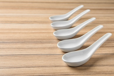 Miso soup spoons on wooden table. Space for text