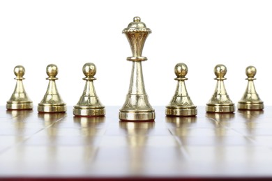 Photo of Queen among pawns on wooden chess board against white background