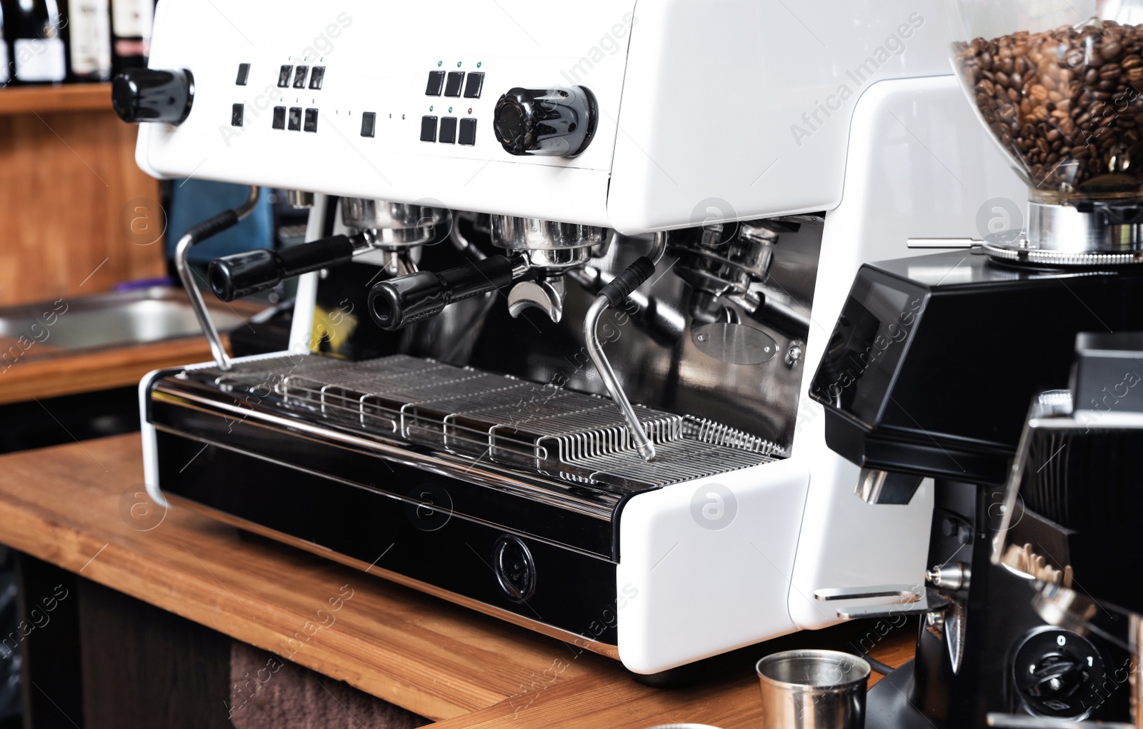 Photo of Modern coffee machine on bar counter in cafe