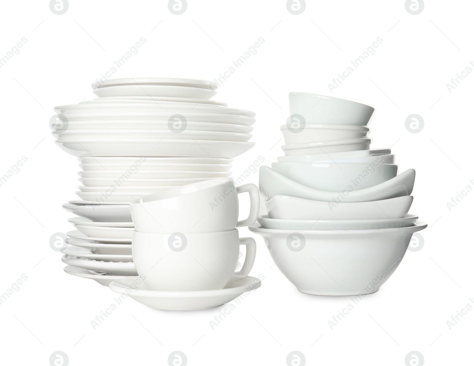 Photo of Set of clean dishware isolated on white