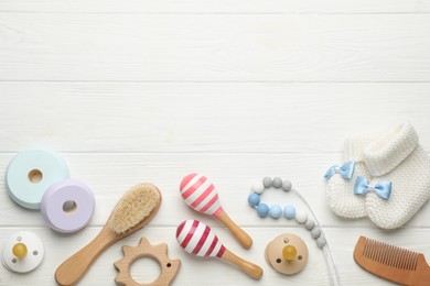 Photo of Baby toys and accessories on white wooden background, flat lay. Space for text