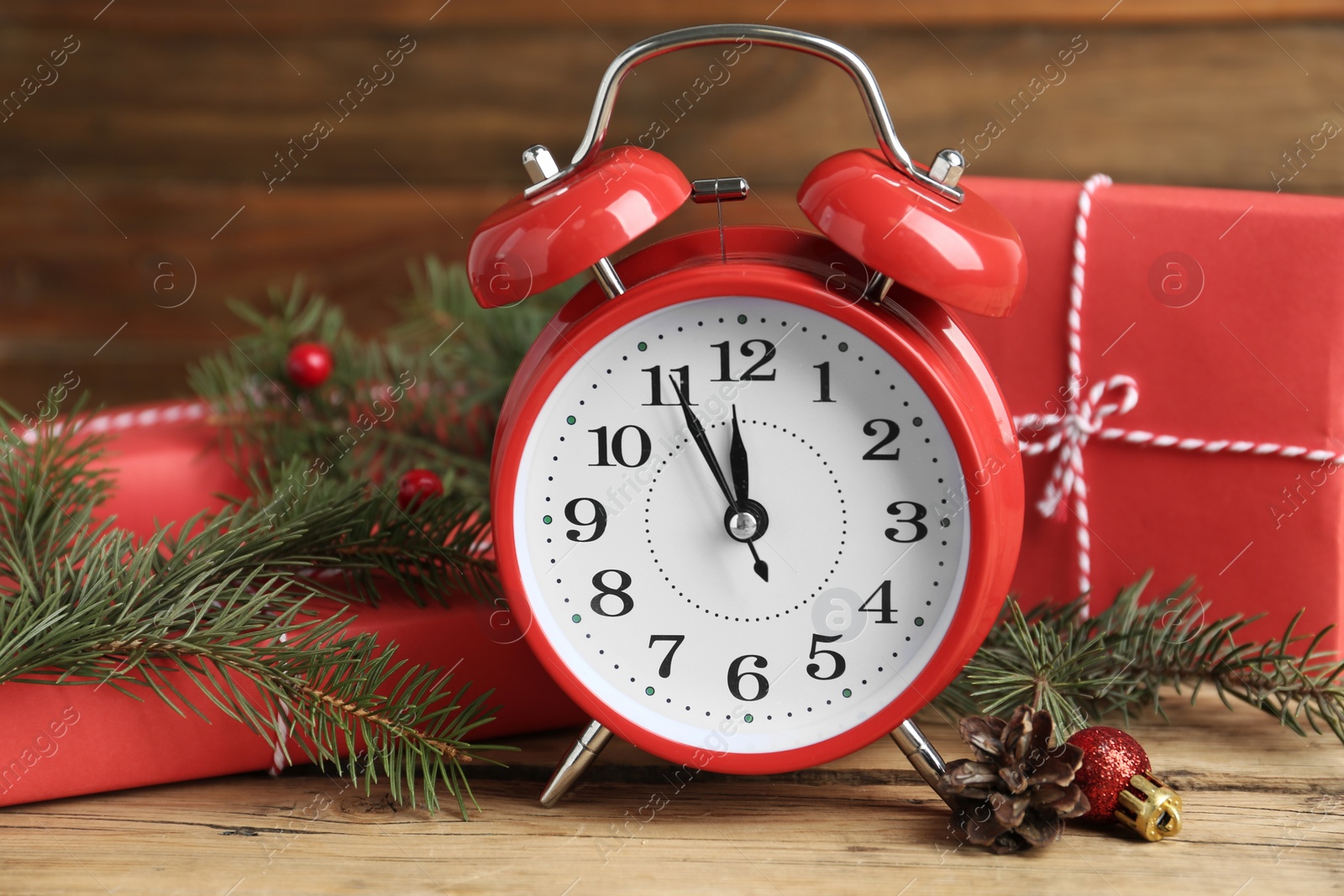 Photo of Beautiful composition with alarm clock and Christmas gifts, closeup. Boxing day