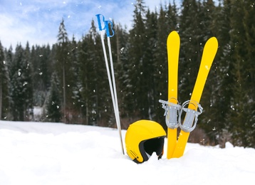 Photo of Ski equipment in snow outdoors, space for text. Winter vacation