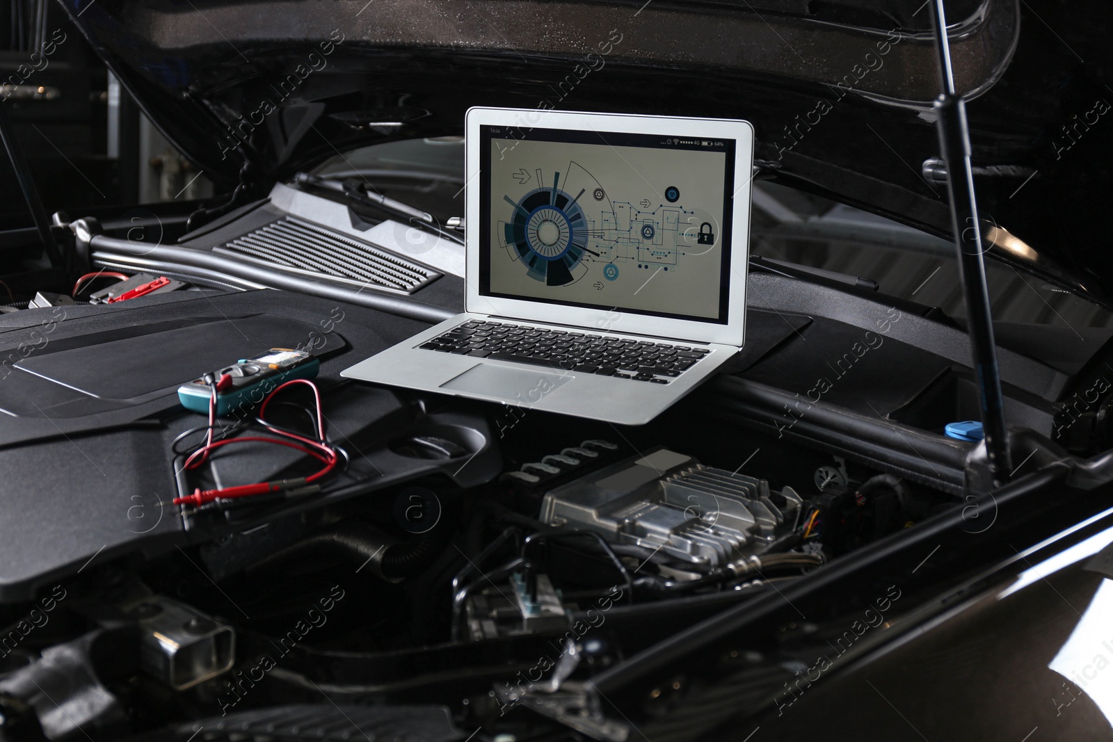 Photo of Laptop with diagram on auto engine. Modern car diagnostic