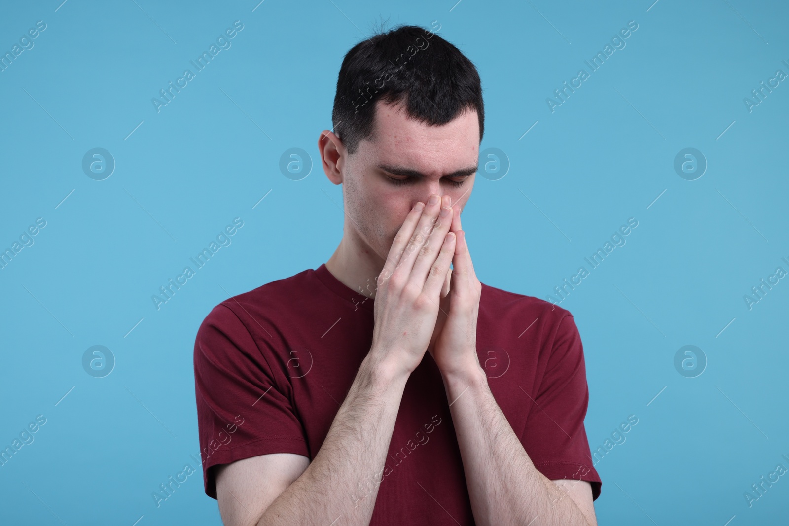 Photo of Portrait of sad man on light blue background