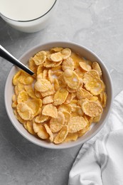 Photo of Tasty cornflakes with milk served on grey marble table, flat lay