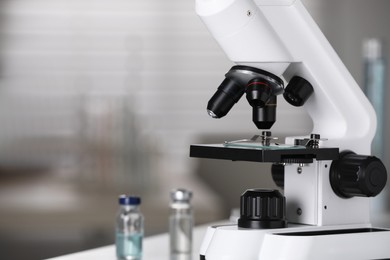 Modern medical microscope on blurred background, closeup with space for text. Laboratory equipment