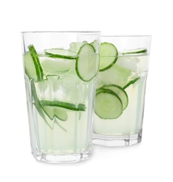 Glasses of refreshing cucumber lemonade and rosemary on white background. Summer drink