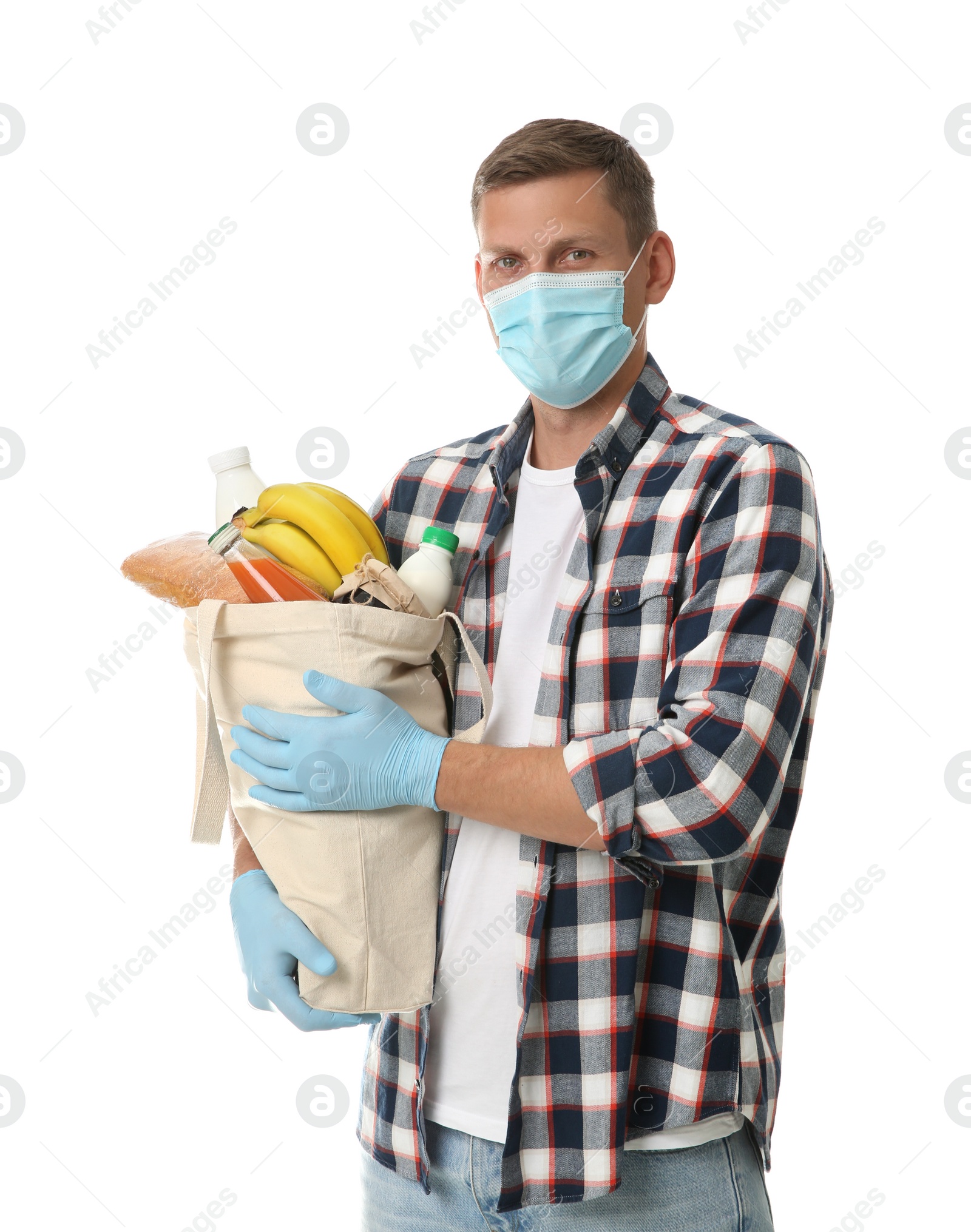 Photo of Male volunteer in protective mask and gloves with products on white background. Aid during coronavirus quarantine