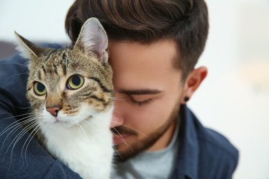Photo of Man with cat at home. Friendly pet