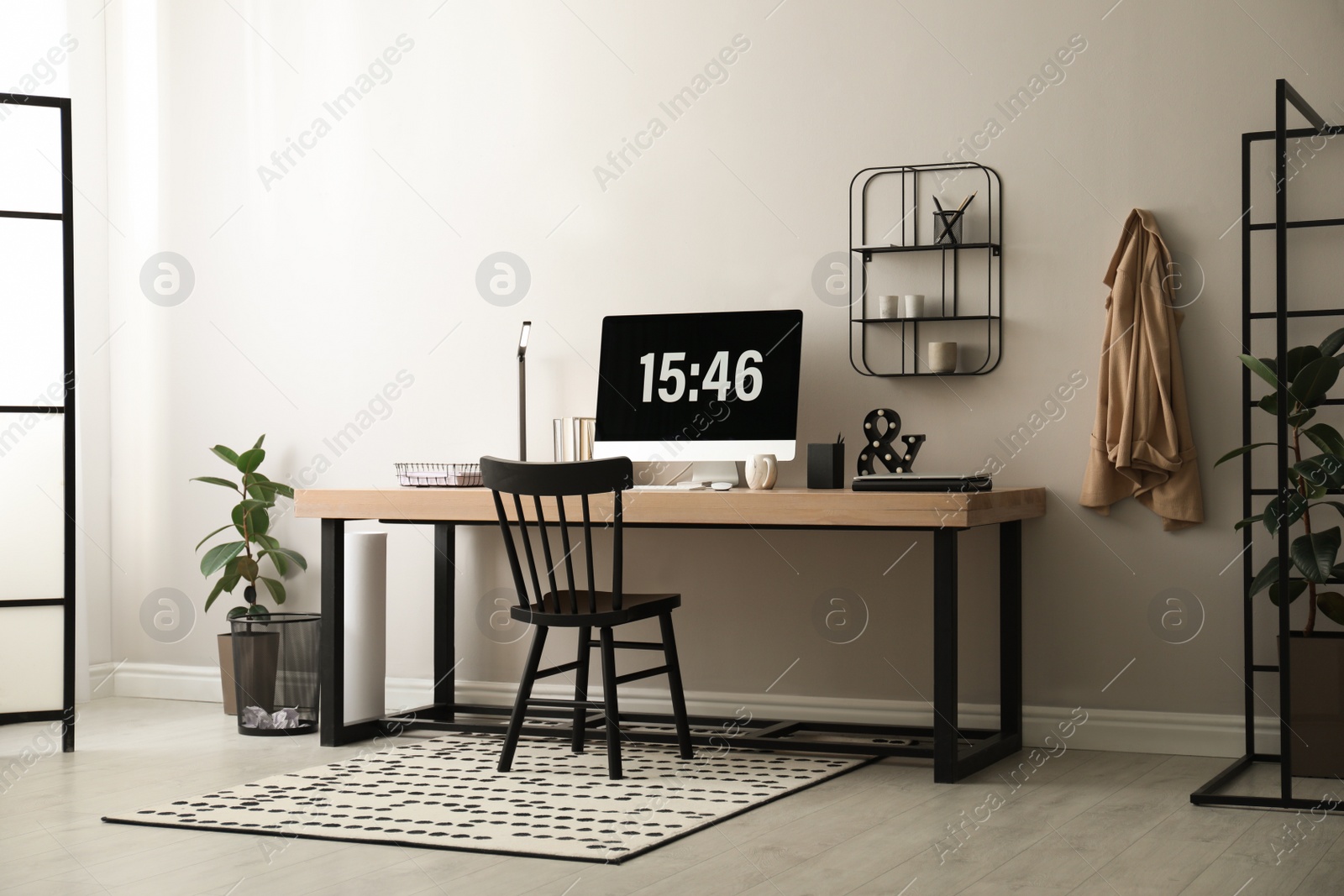 Photo of Modern workplace with computer in room. Interior design