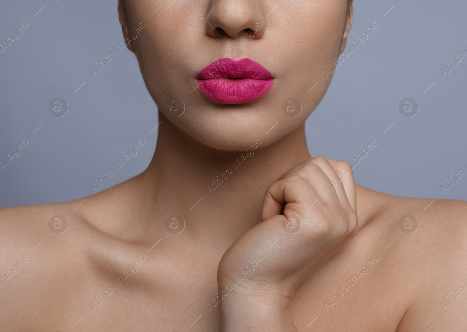 Photo of Closeup view of woman with beautiful full lips on grey background