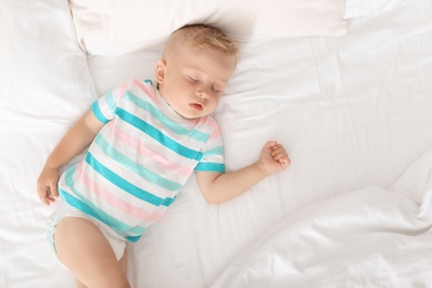 Photo of Little child sleeping on bed at home