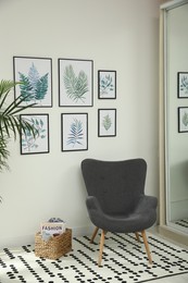 Photo of Beautiful paintings of tropical leaves on white wall in room interior