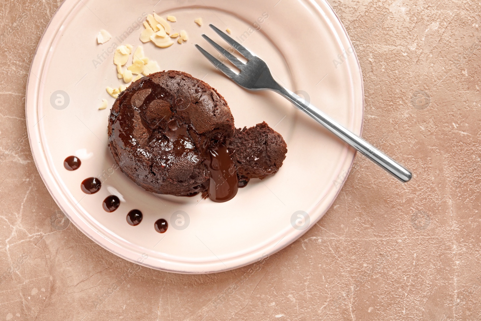 Photo of Plate of delicious fresh fondant with hot chocolate on table, top view. Lava cake recipe