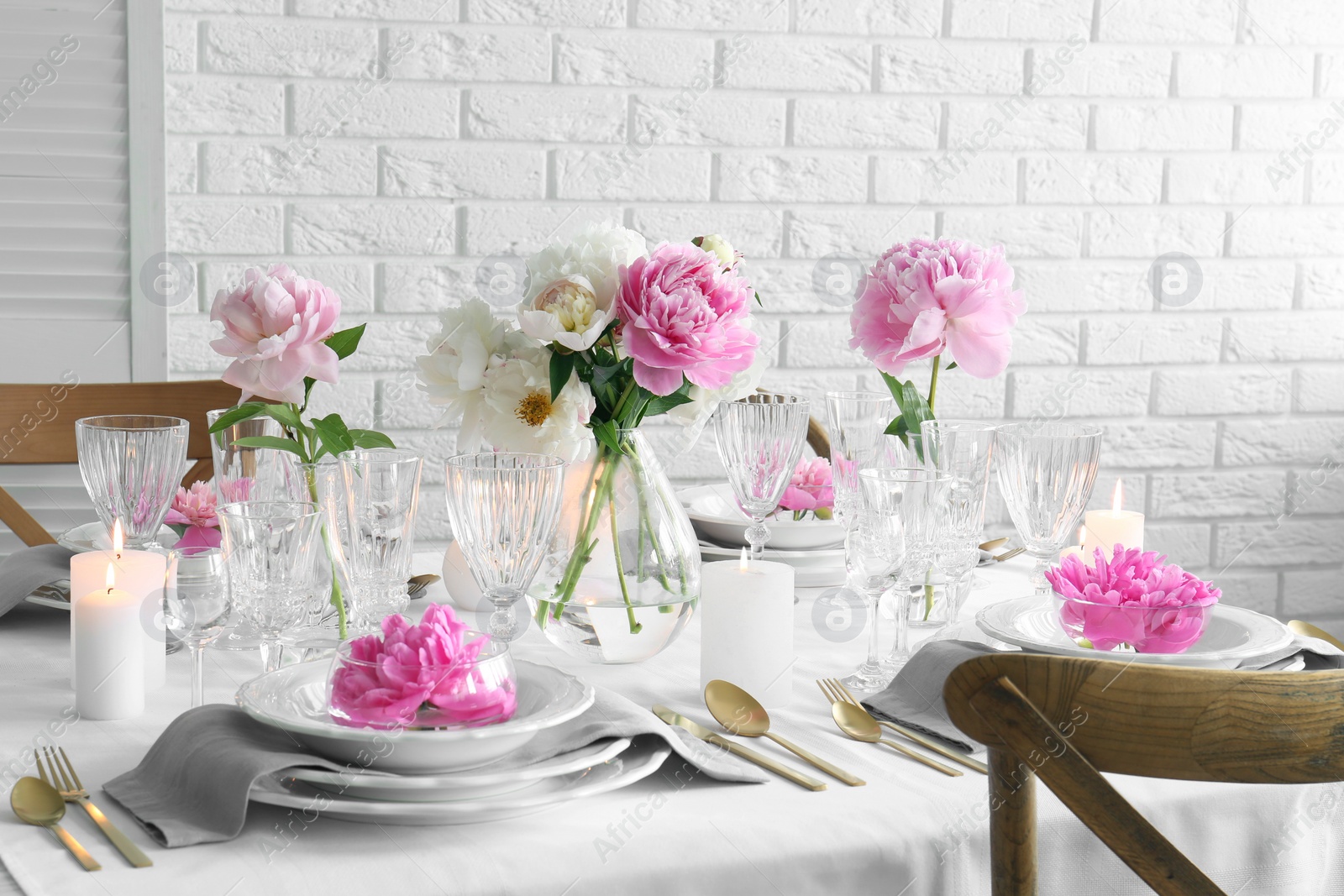 Photo of Stylish table setting with beautiful peonies in dining room