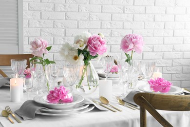 Photo of Stylish table setting with beautiful peonies in dining room