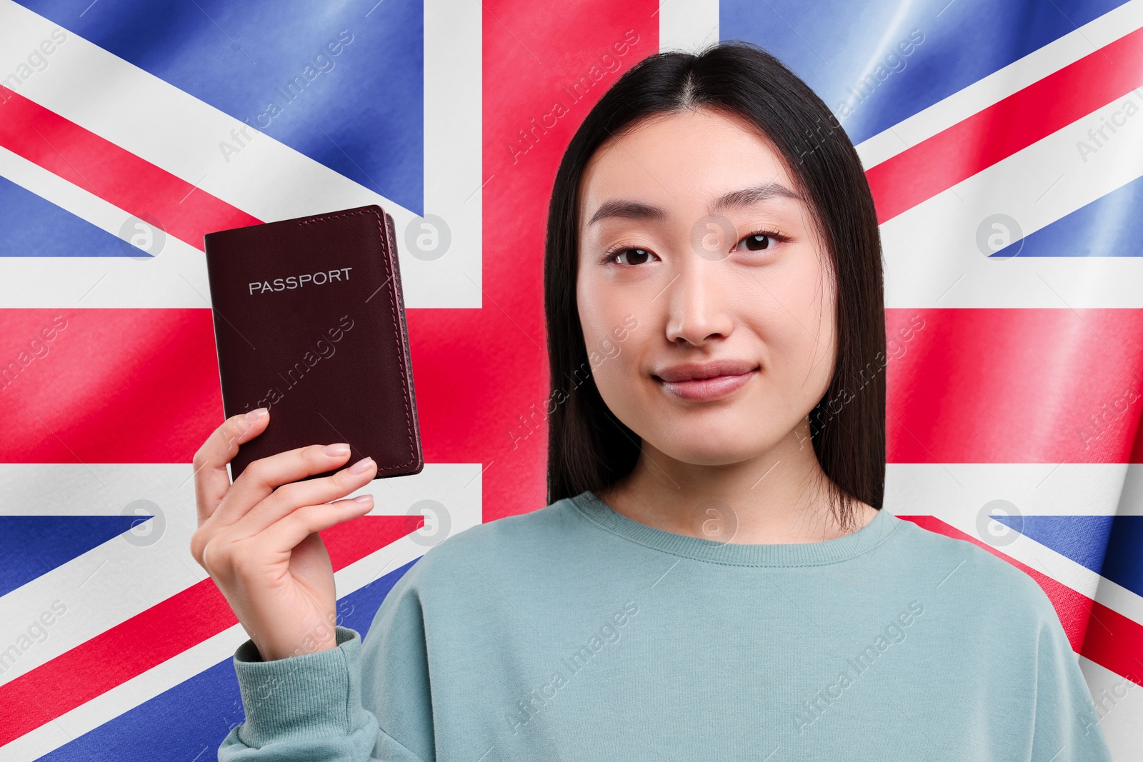 Image of Immigration. Woman with passport against national flag of United Kingdom