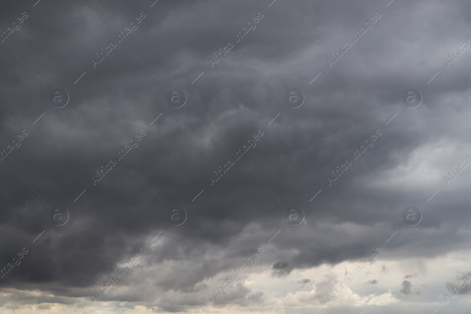 Photo of Sky with heavy rainy clouds on grey day