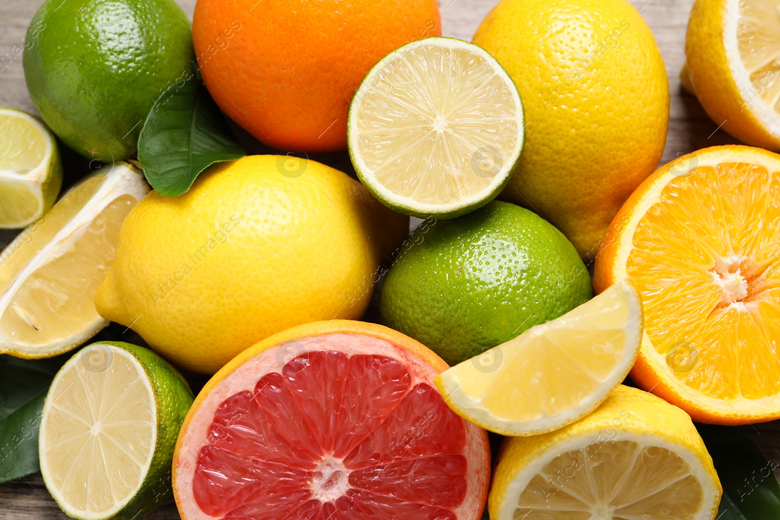 Photo of Different fresh citrus fruits on table, above view