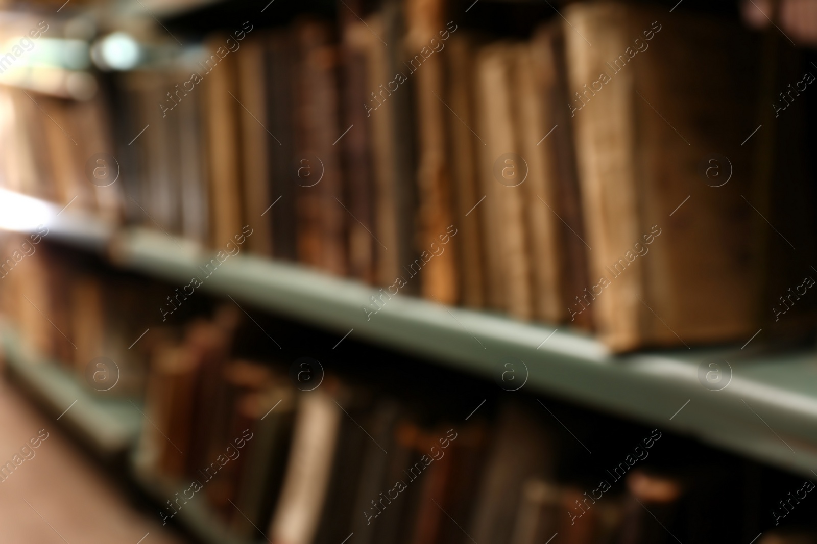 Photo of Blurred view of books on shelves in library