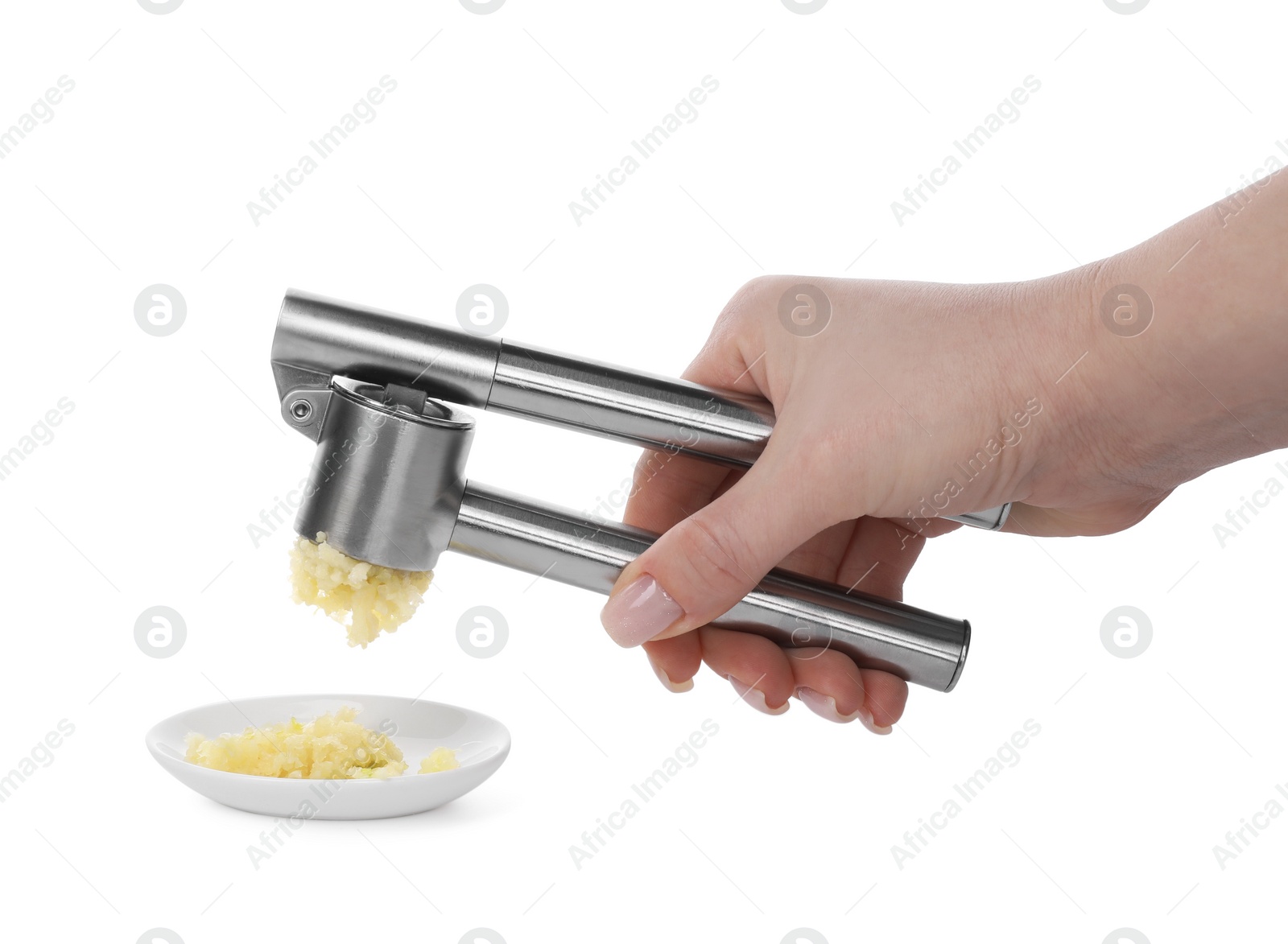 Photo of Woman squeezing garlic with press on white background, closeup