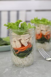 Photo of Healthy salad in glass jar on marble table