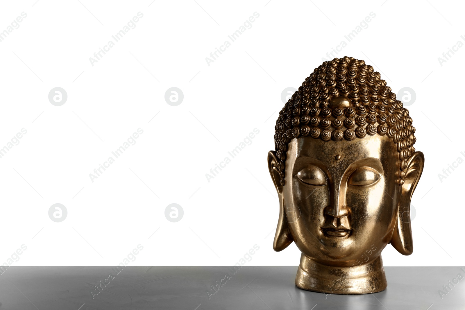 Photo of Beautiful golden Buddha sculpture on table against grey background. Space for text
