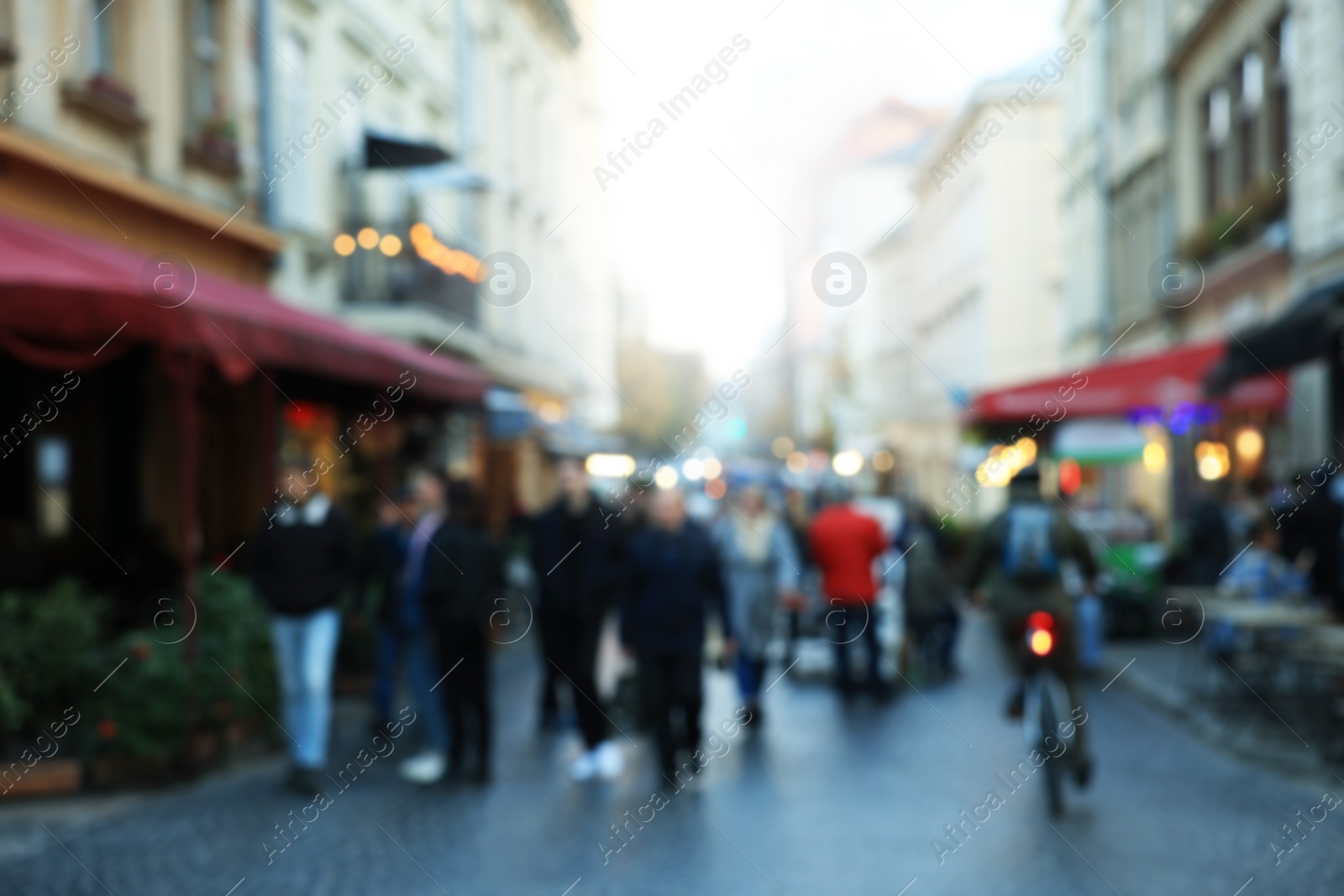 Photo of Blurred view of people walking on city street